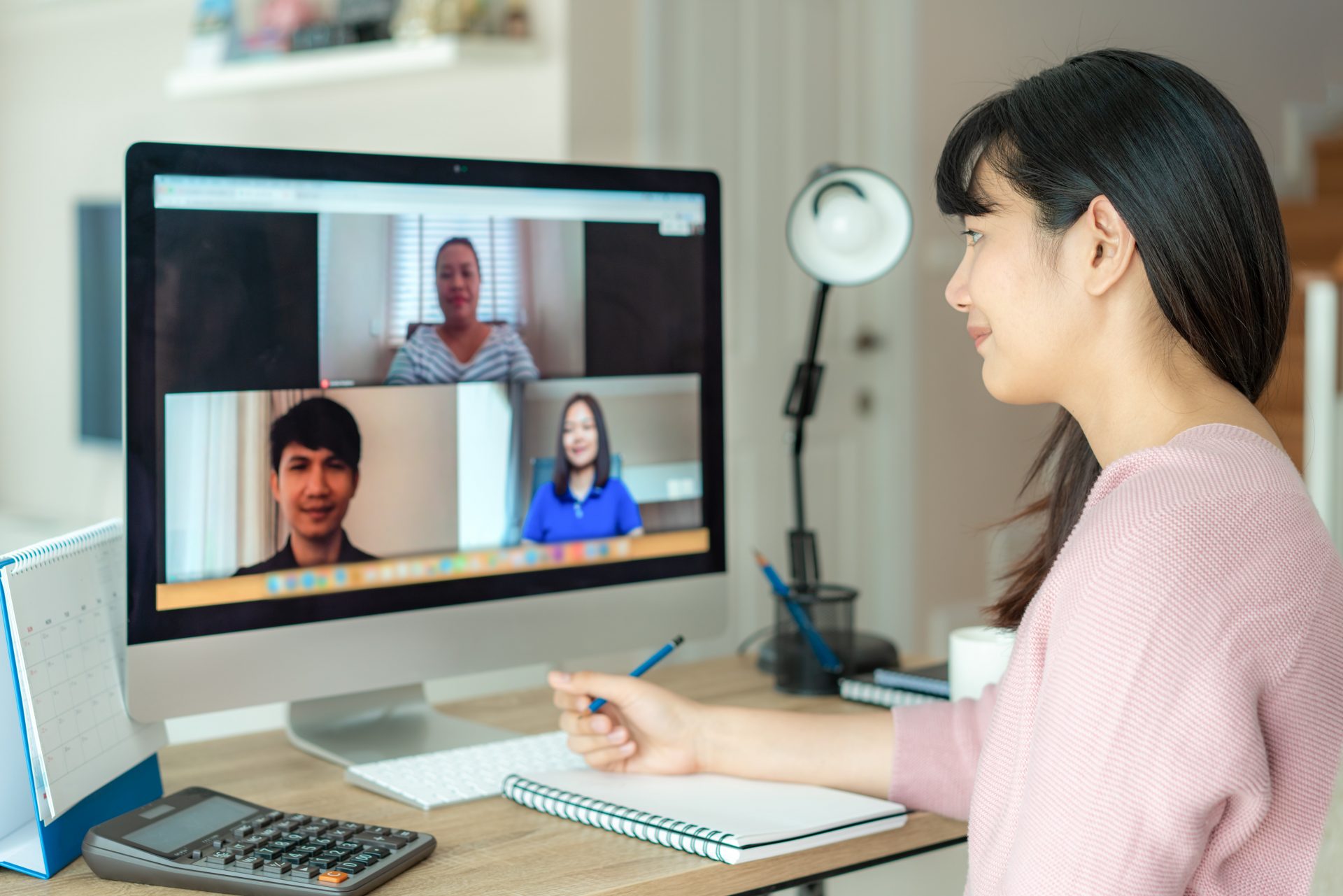 Female professional working from home and sitting in front of her computer on a Zoom call