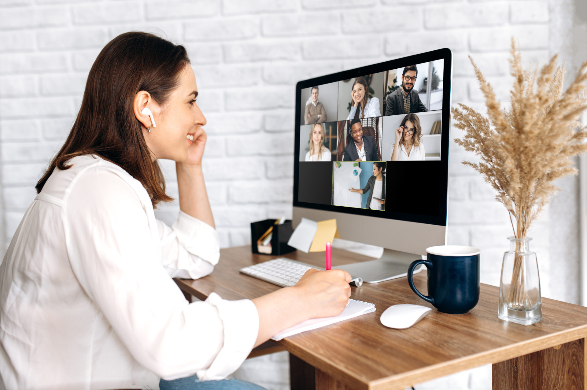 Female professional working from home on a Zoom call with her coworkers