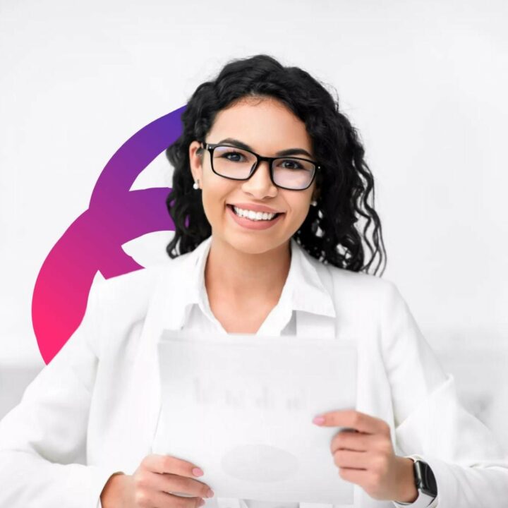 Female recruiter dressed in a white blazer holding documents, looking at camera