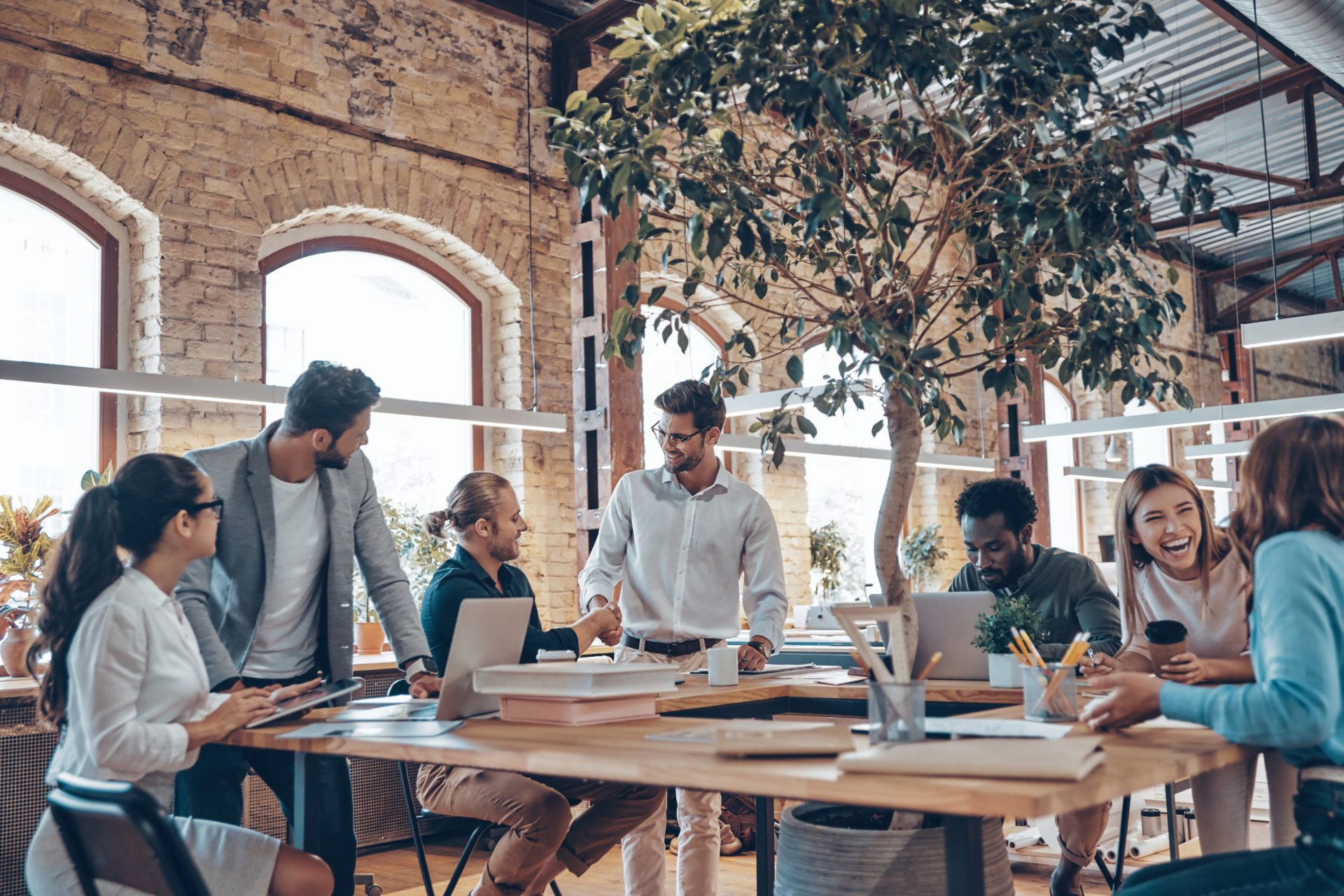 Group of professionals in a modern office communicating and using technology