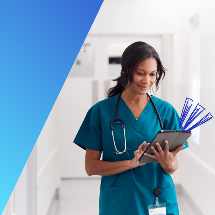 Female doctor wearing scrubs in hospital corridor using digital tablet working an in-demand healthcare job