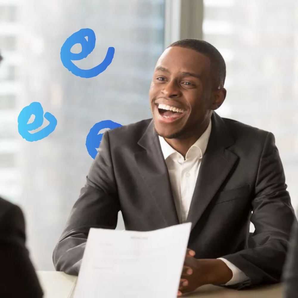 Male professional smiling and engaged during an interview