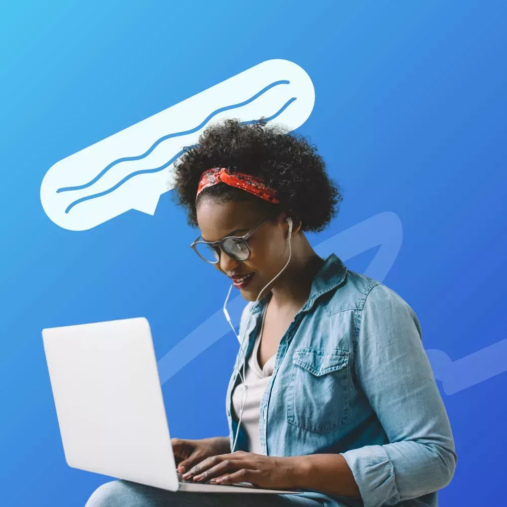 Female wearing headphones typing on her computer writing down her questions on what to ask during a mock interview