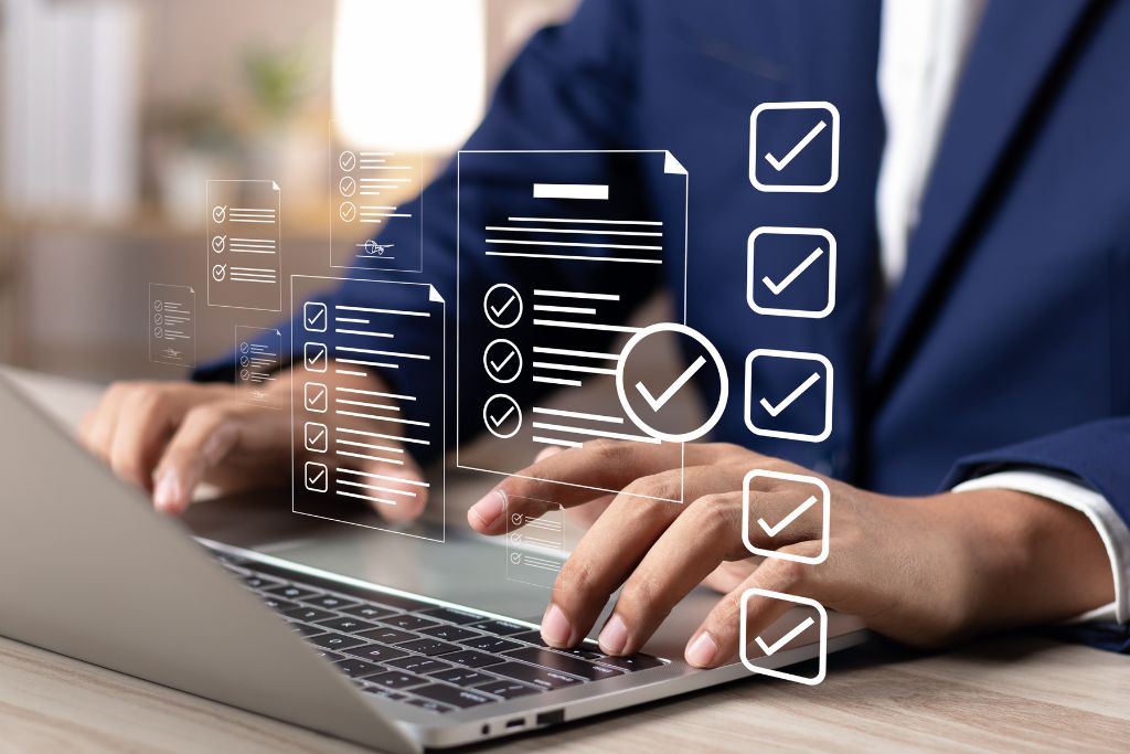 A person in a suit working on a laptop, with digital survey checkboxes and forms displayed in the foreground, representing the use of employee survey tools.